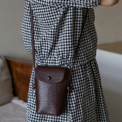 Women's coffee brown leather phone crossbody bag in a casual styling view