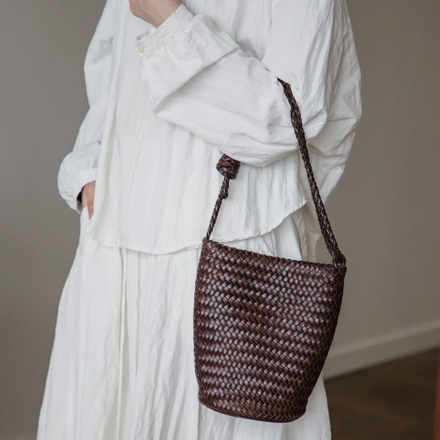 Coffee brown woven leather bucket bag with braided strap