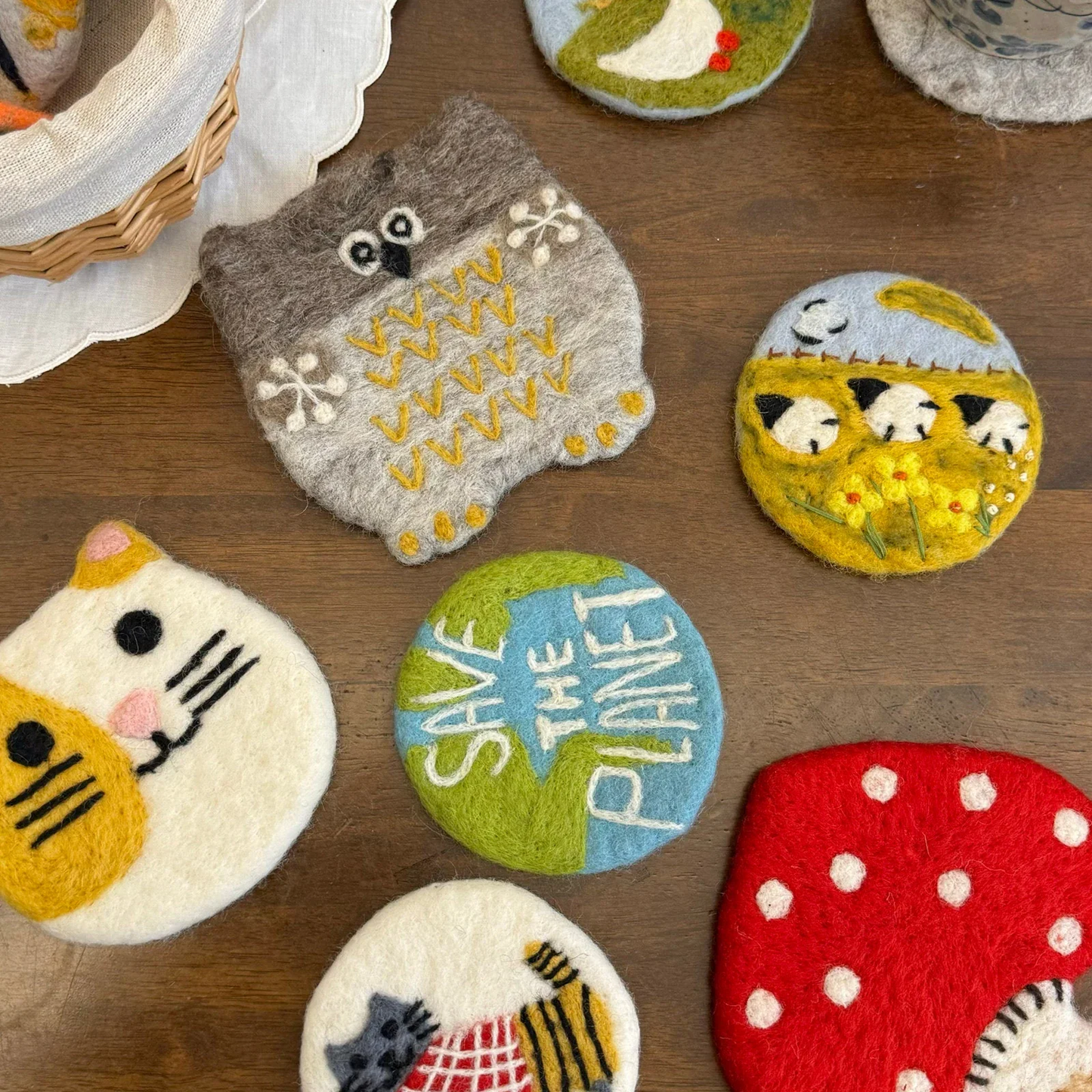 Handmade colorful wool felt coasters in a table setting