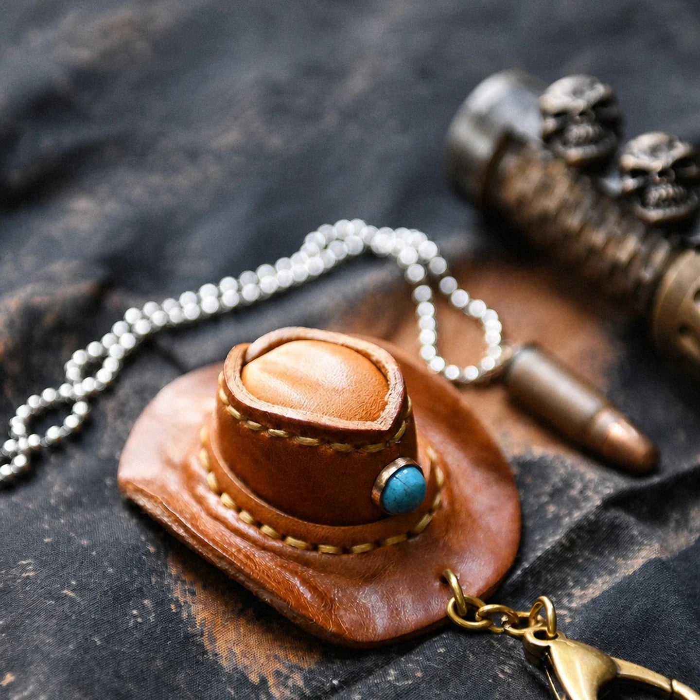 Cowhide mini cowboy hat keychain with brass-tone clasp and blue accent