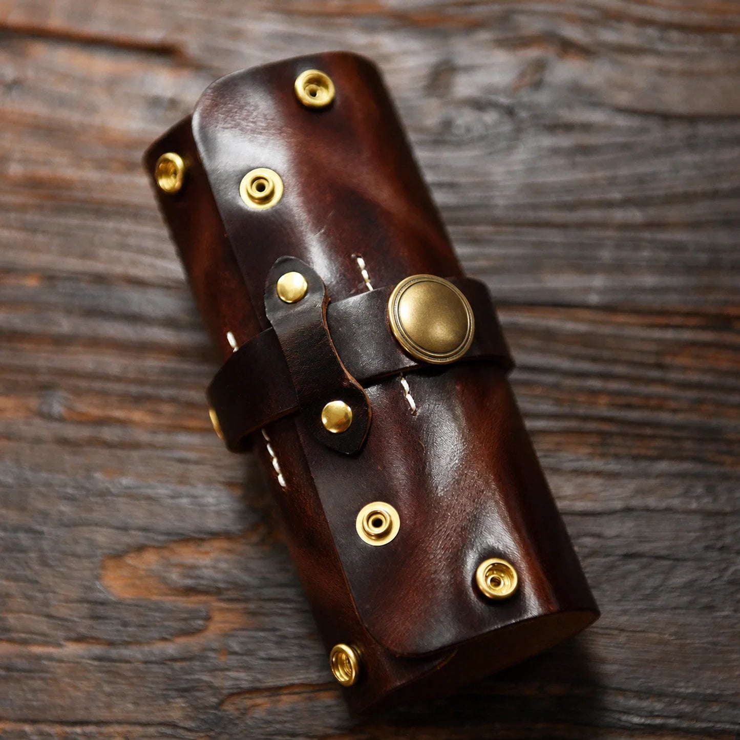 Dark brown hand-stitched leather pipe pouch closed