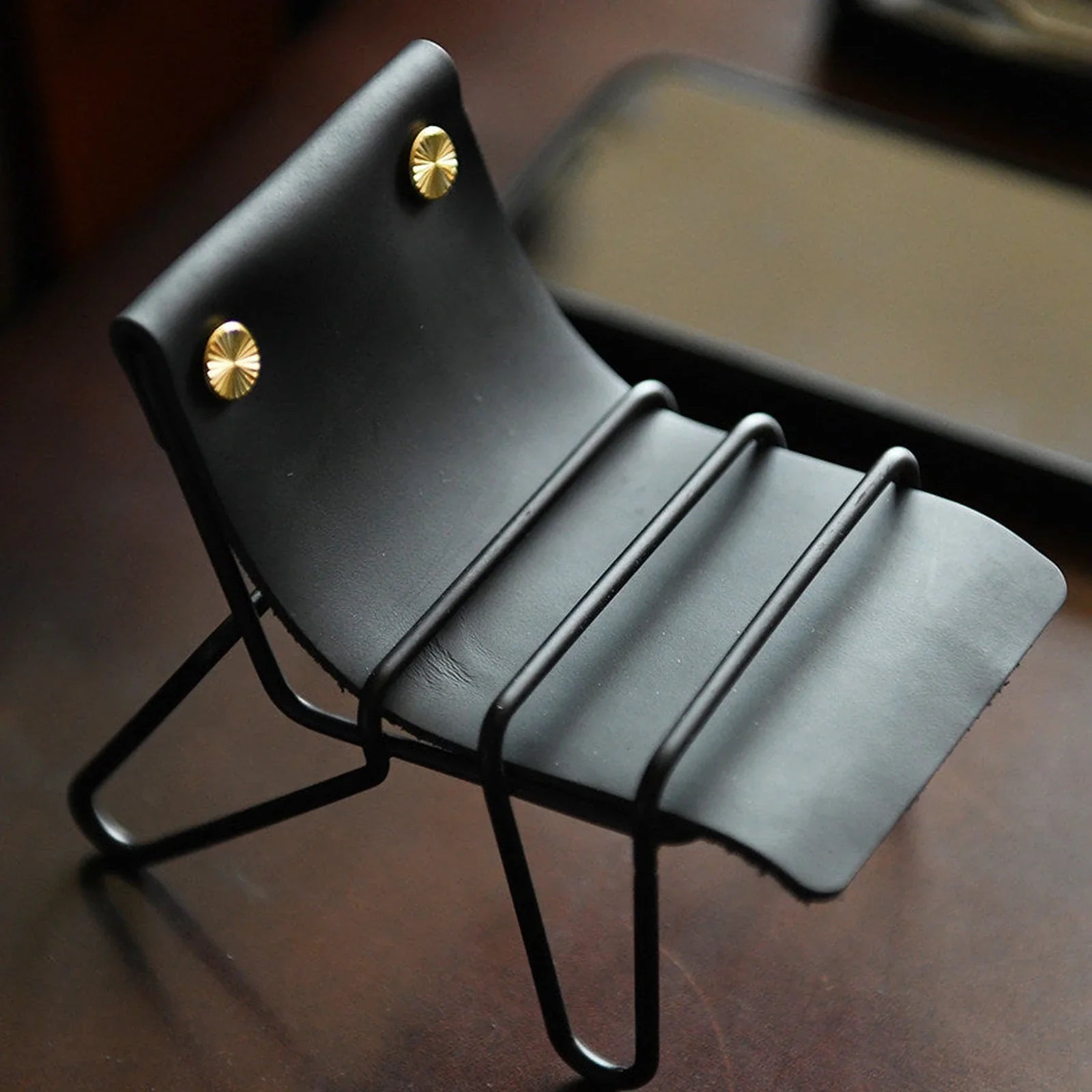 Black leather and metal desktop phone stand full view