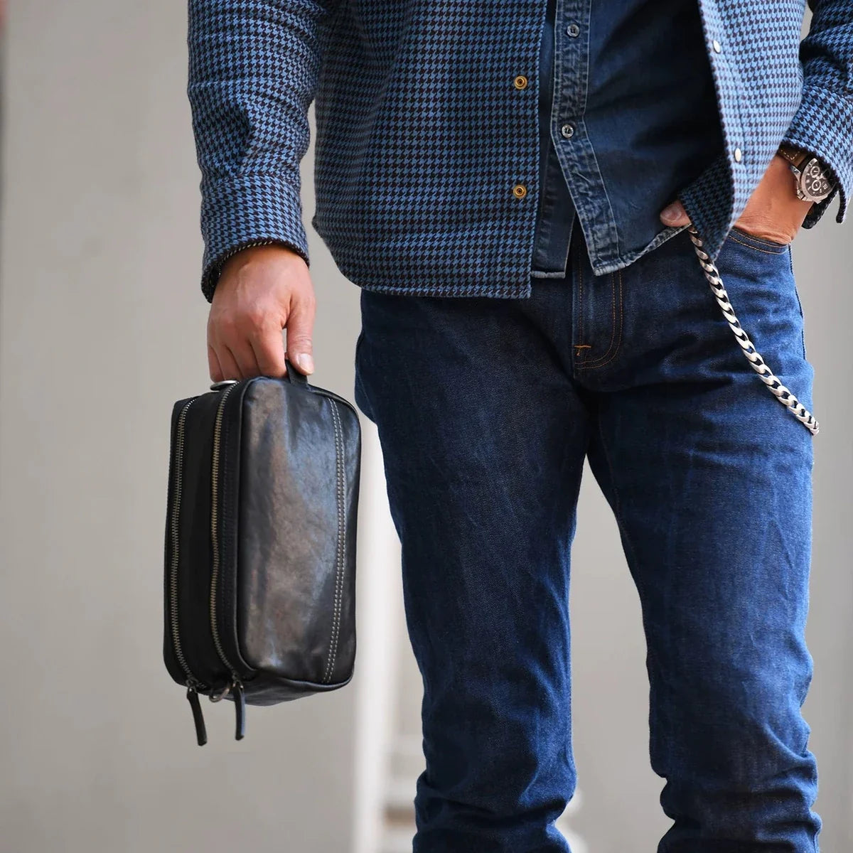 Men's black leather bag carried by hand