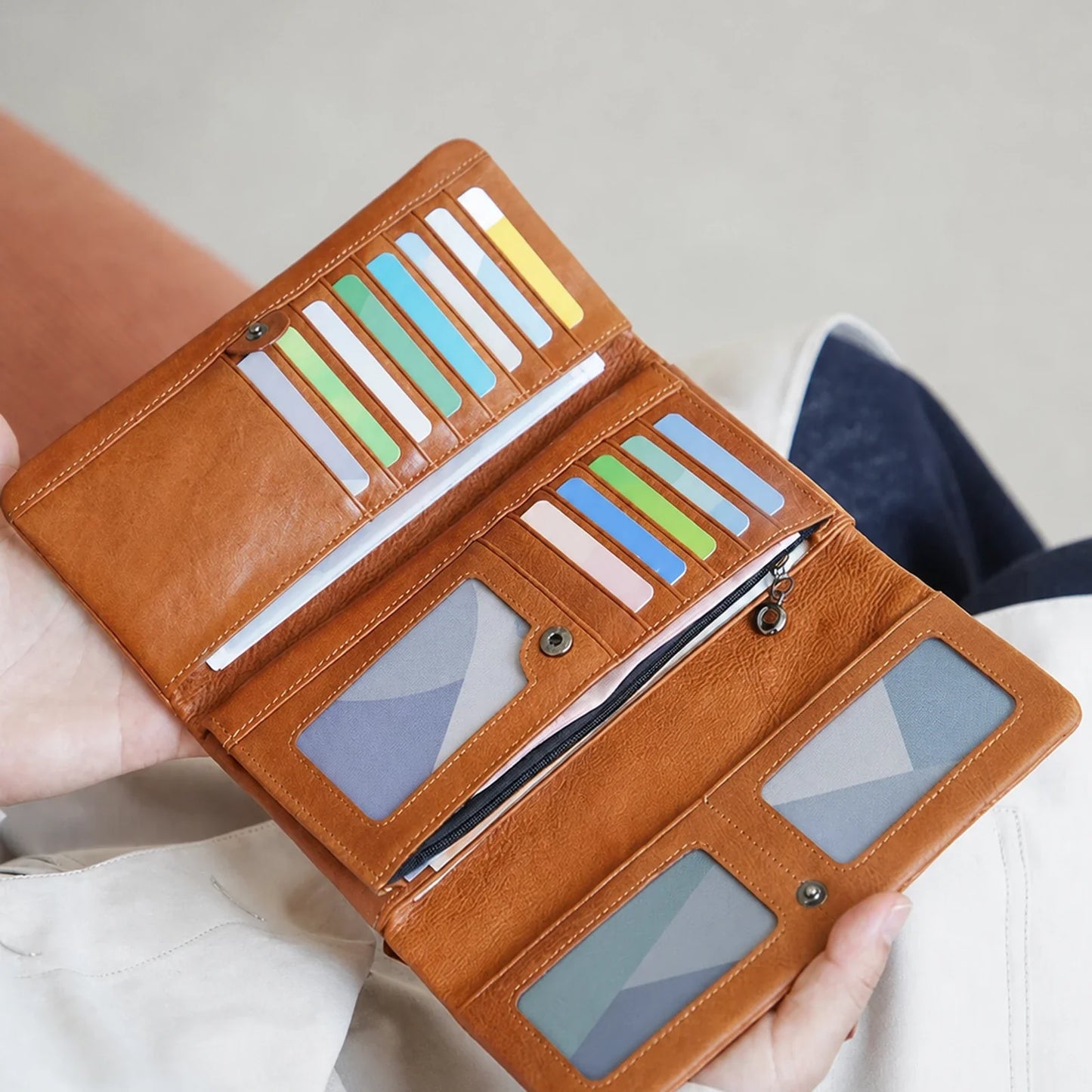 Open cognac leather wallet showing its multi-card interior