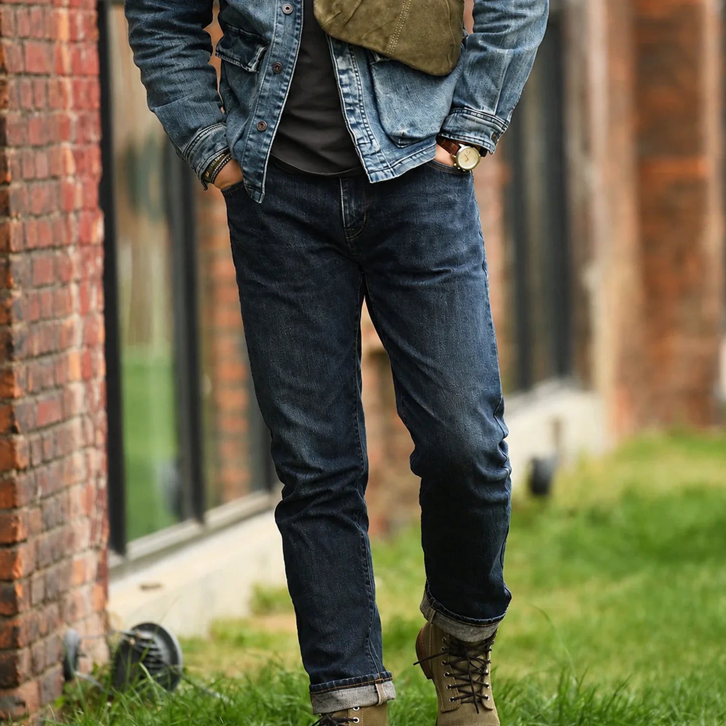 Men’s army green canvas sling bag styled with denim