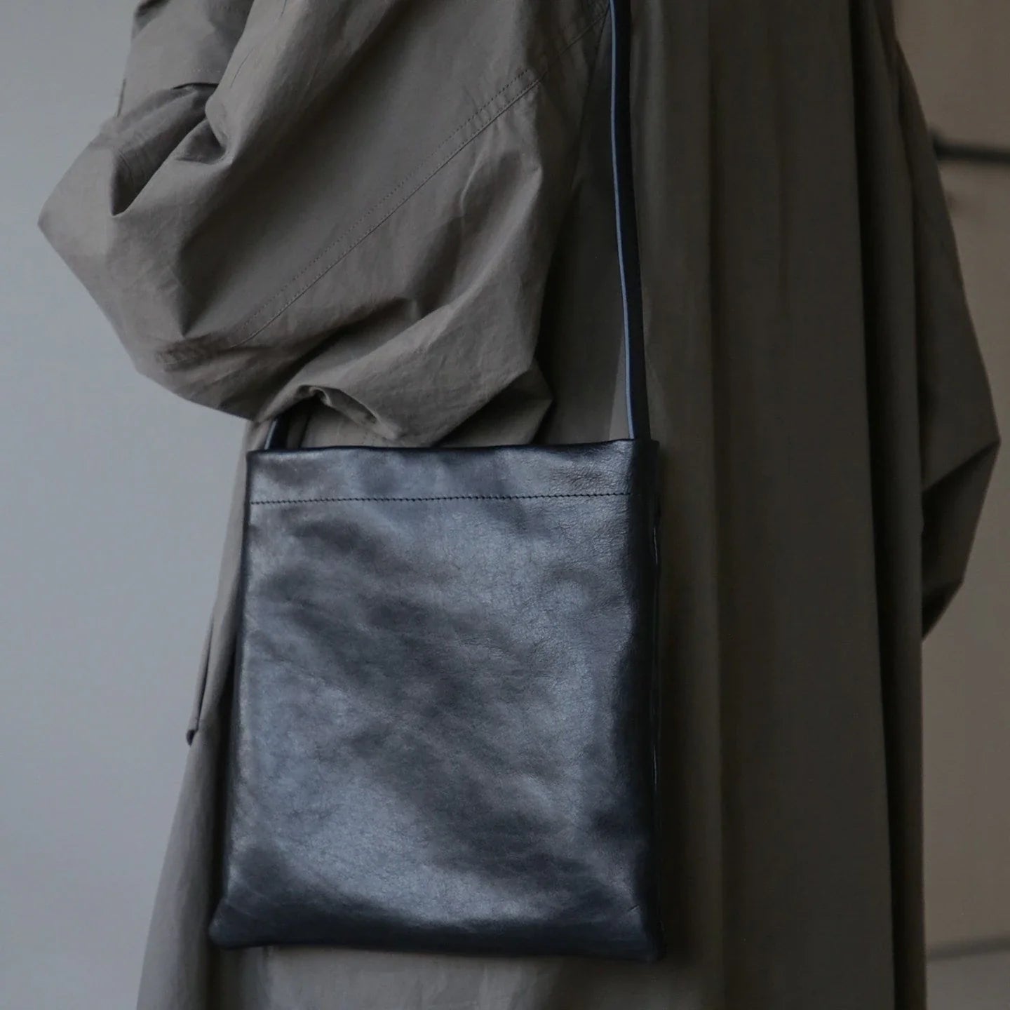 Front view of the black top-grain leather shoulder bag