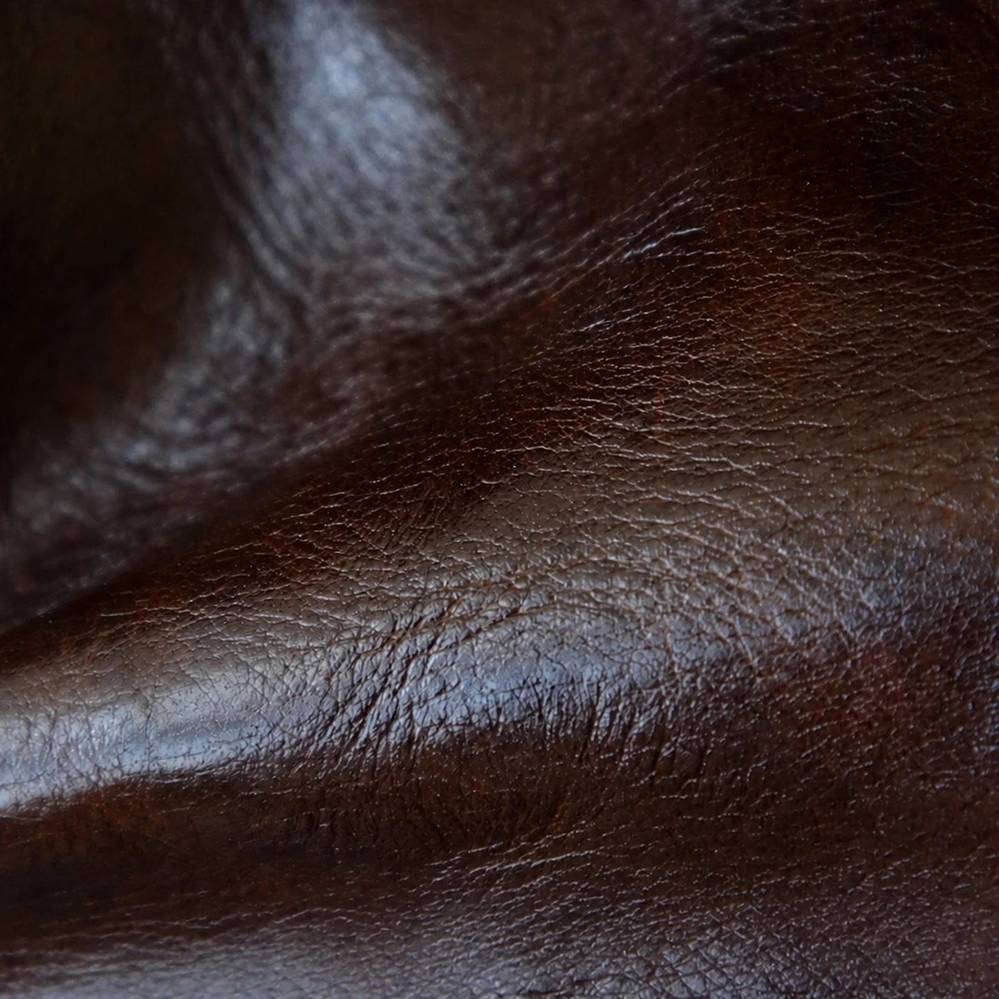 Close-up detail of the brown vegetable-tanned top-grain leather surface