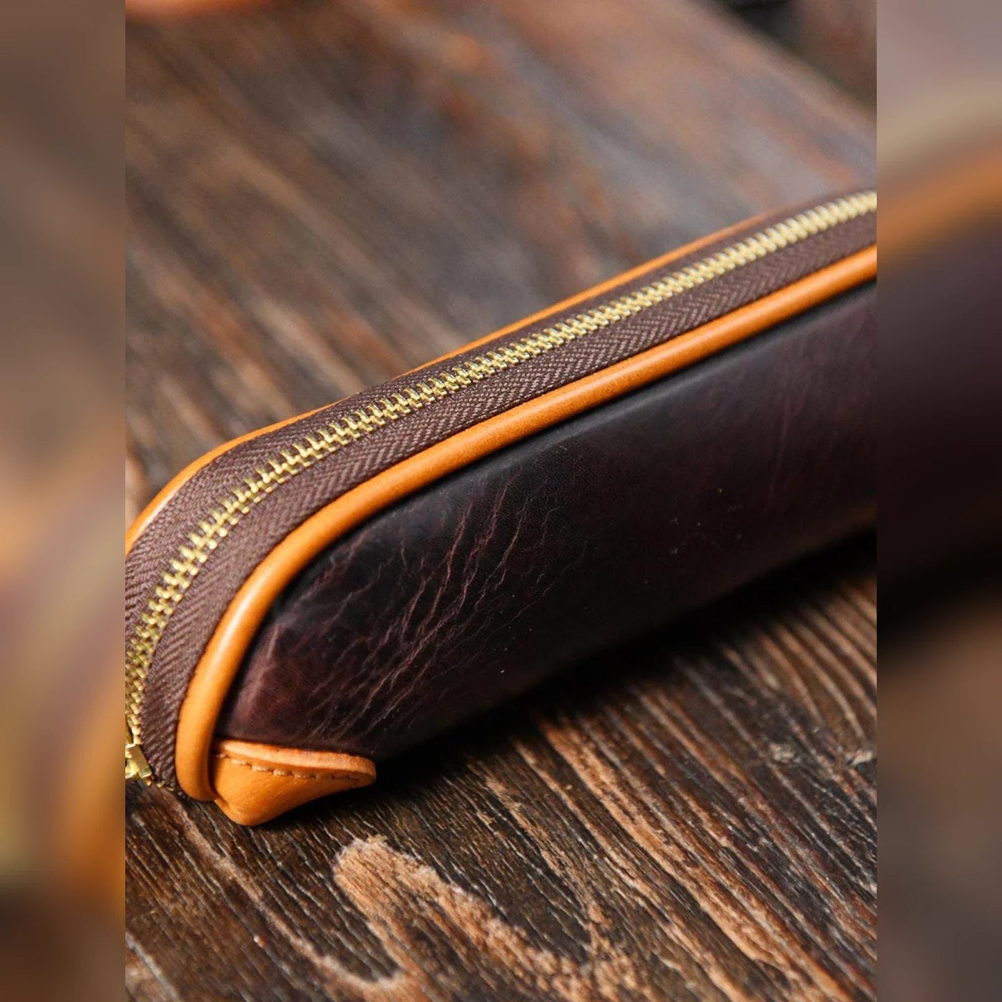 Close detail of zipper, piping, and natural leather grain