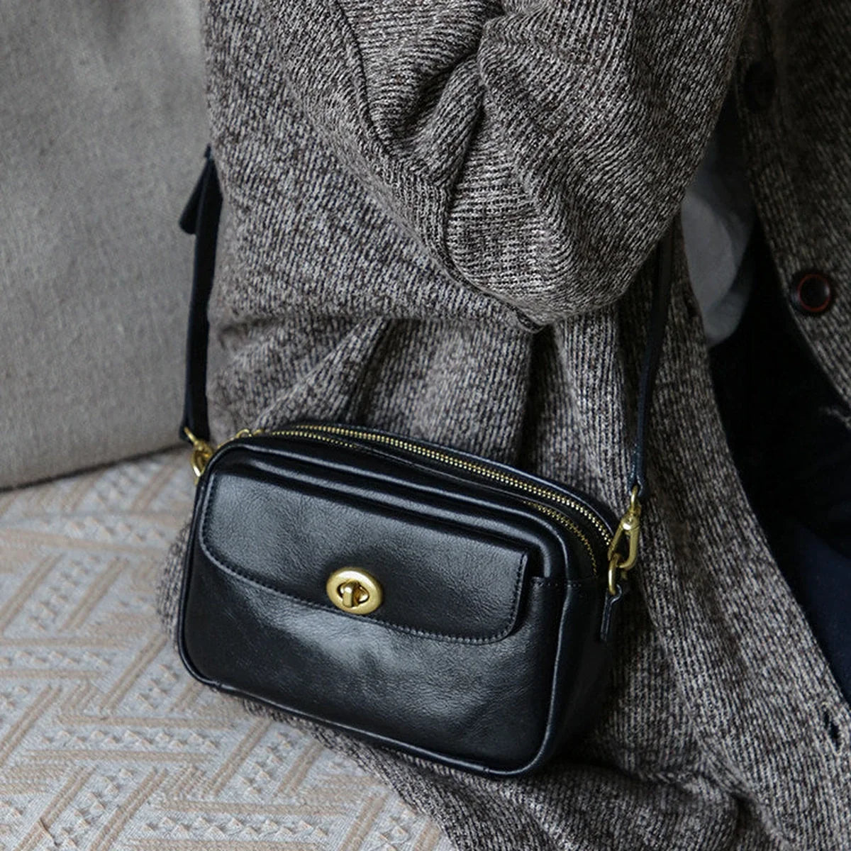 Black leather crossbody phone bag styled at the side