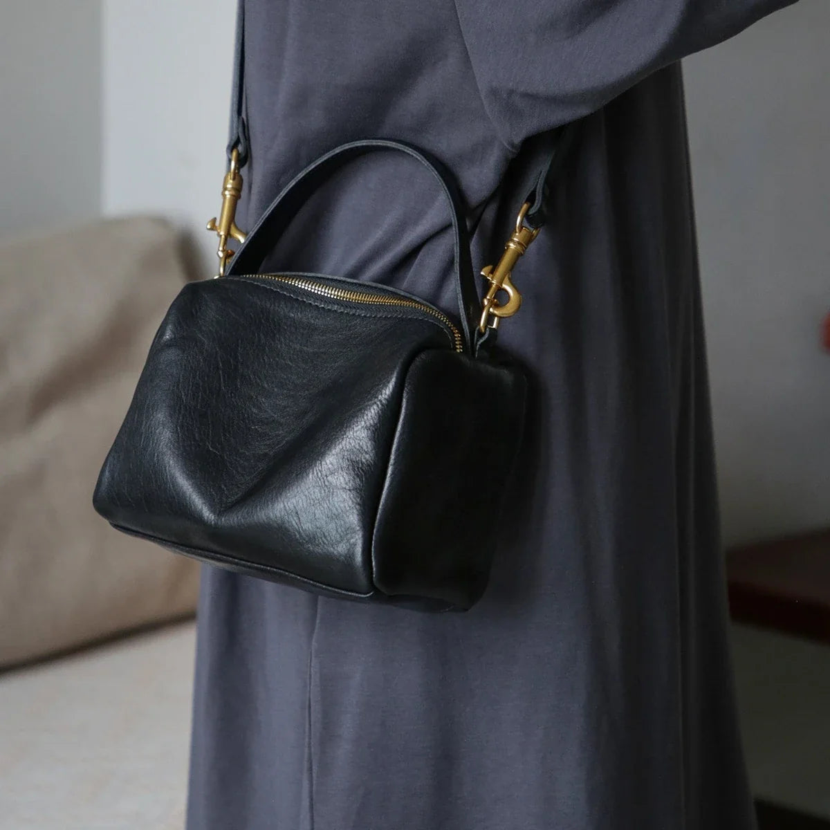 Women's black leather square bag worn crossbody