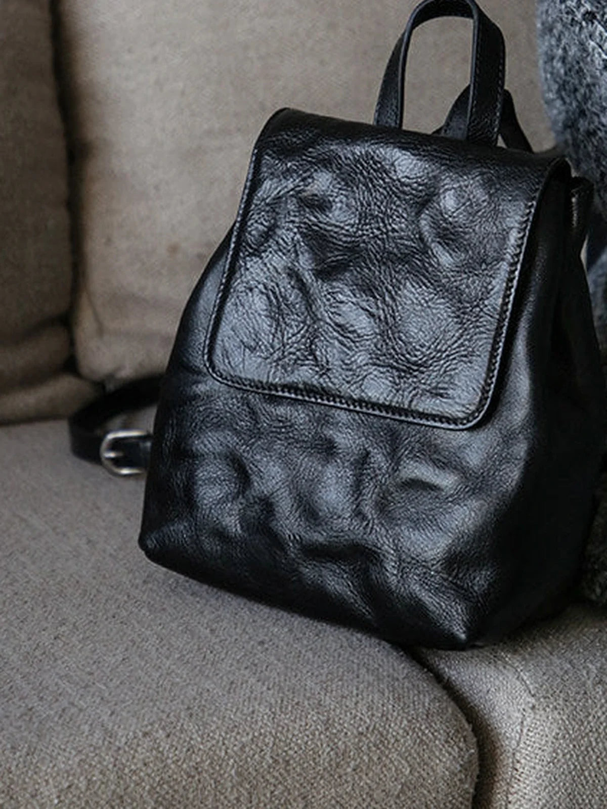Close detail of the black cowhide grain and front flap