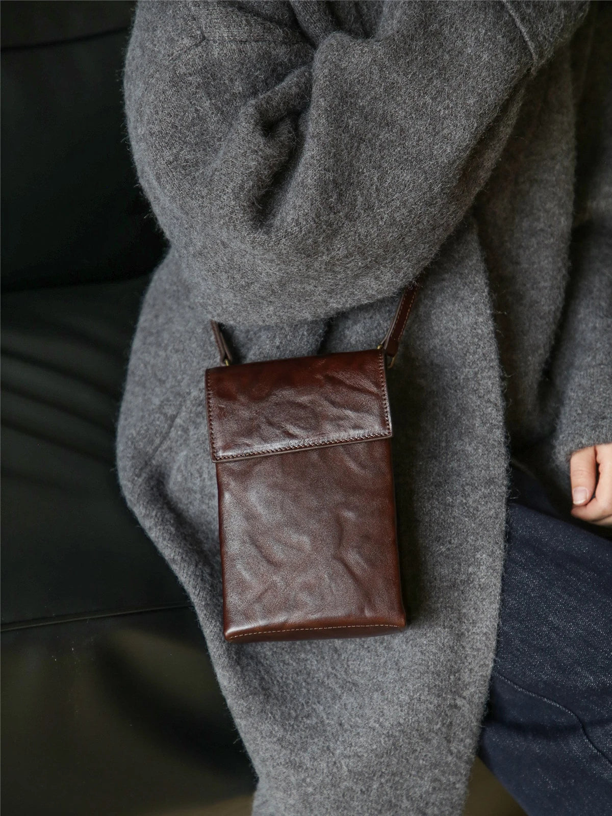 Brown leather phone bag styled at the hip