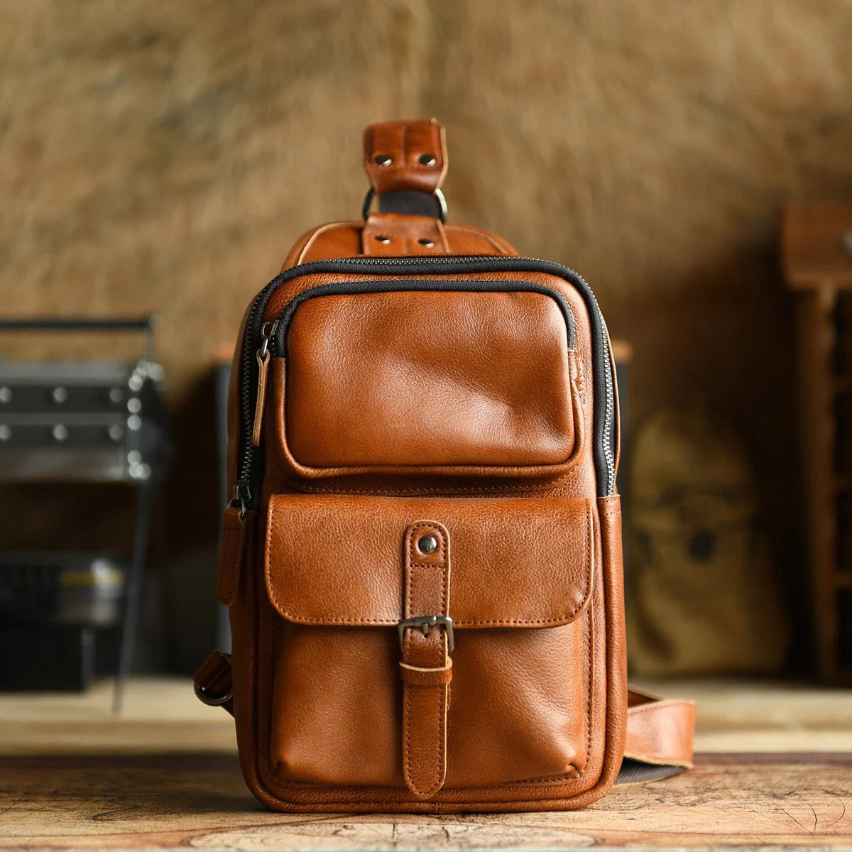 Brown leather sling bag studio front view
