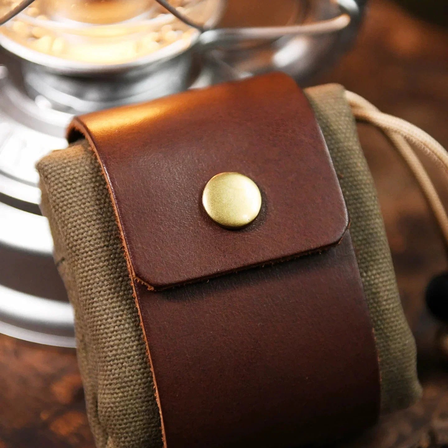 Close-up of canvas belt pouch with leather flap and metal snap