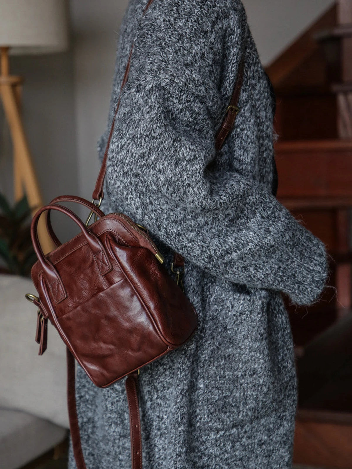 Coffee brown leather mini backpack styled as a shoulder bag