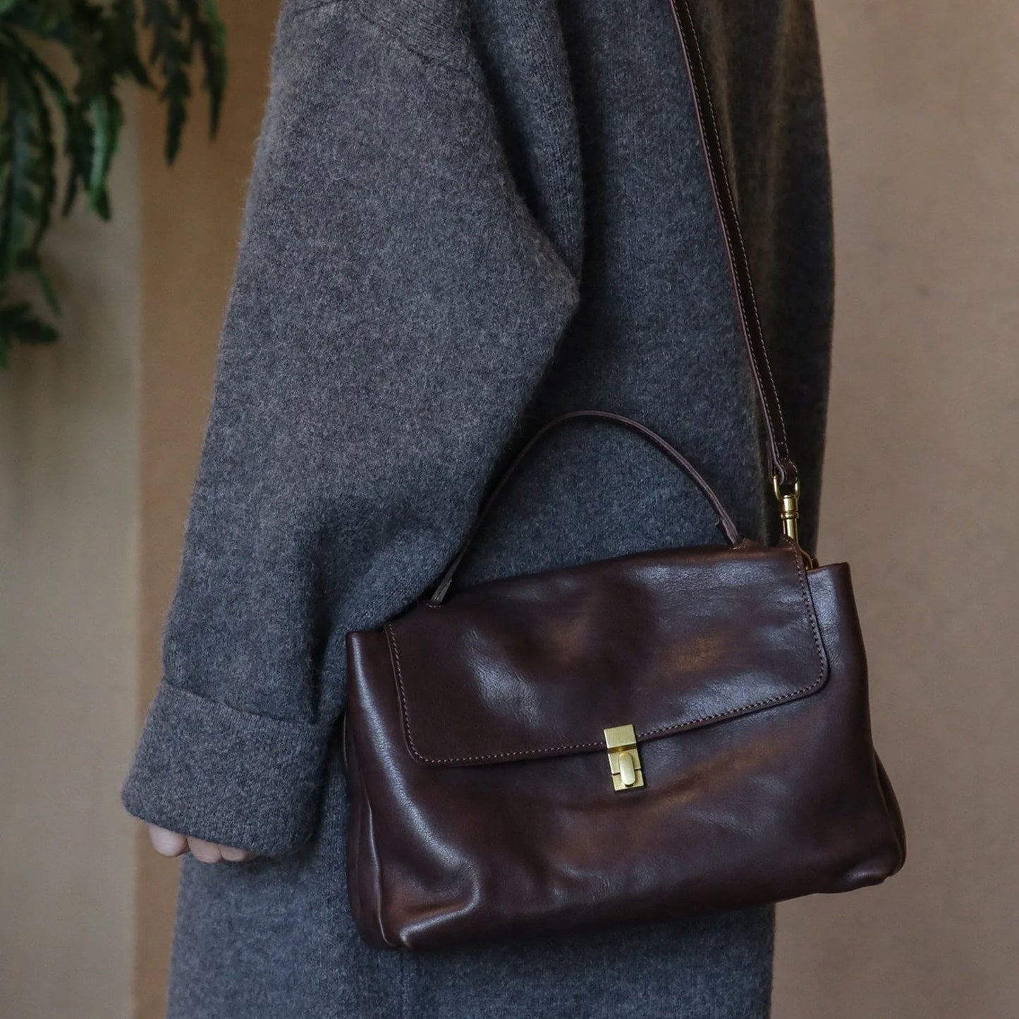 Coffee Brown leather tote bag worn on the shoulder