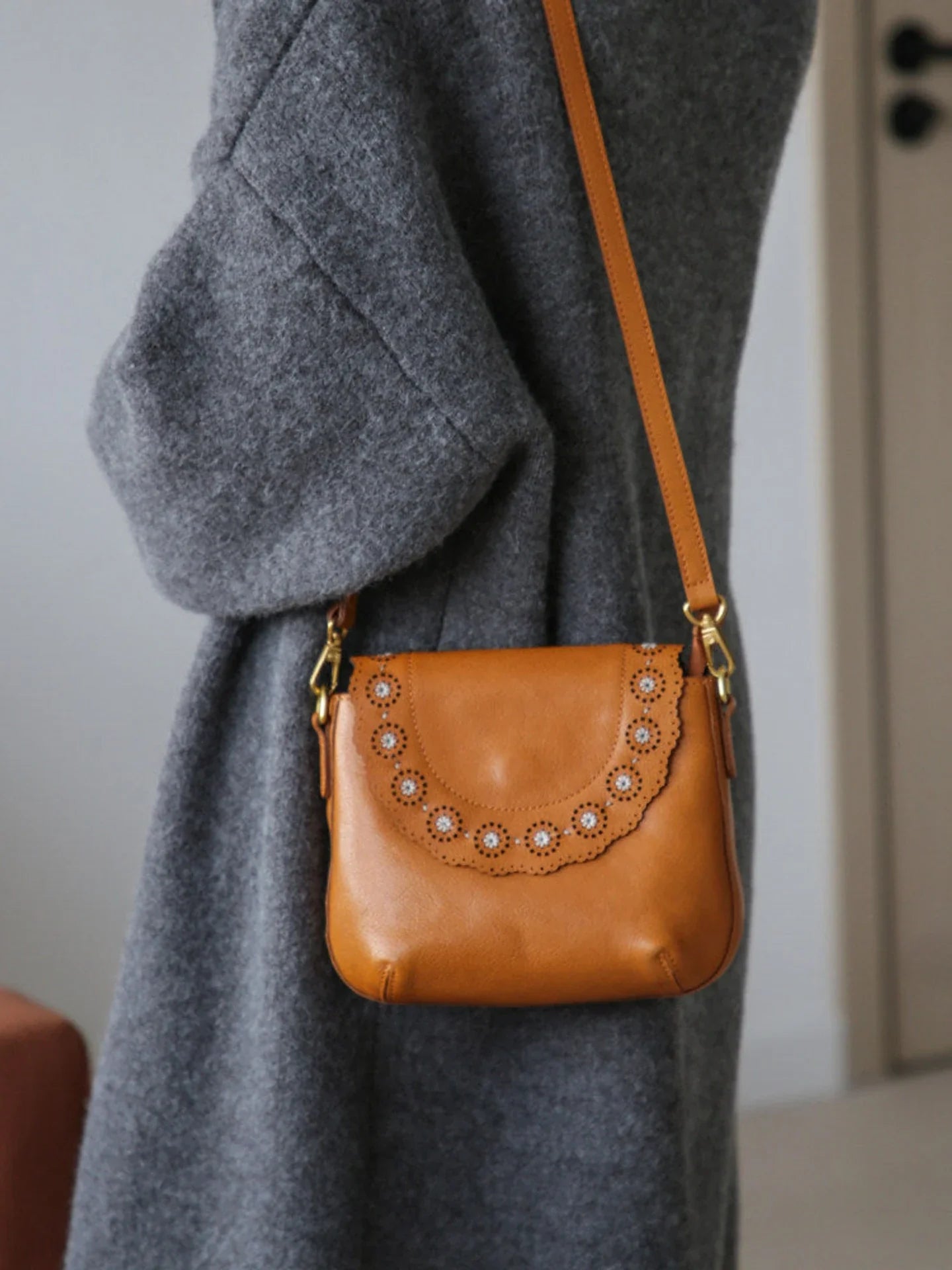 Cognac brown leather bag with scalloped floral cutout flap detail