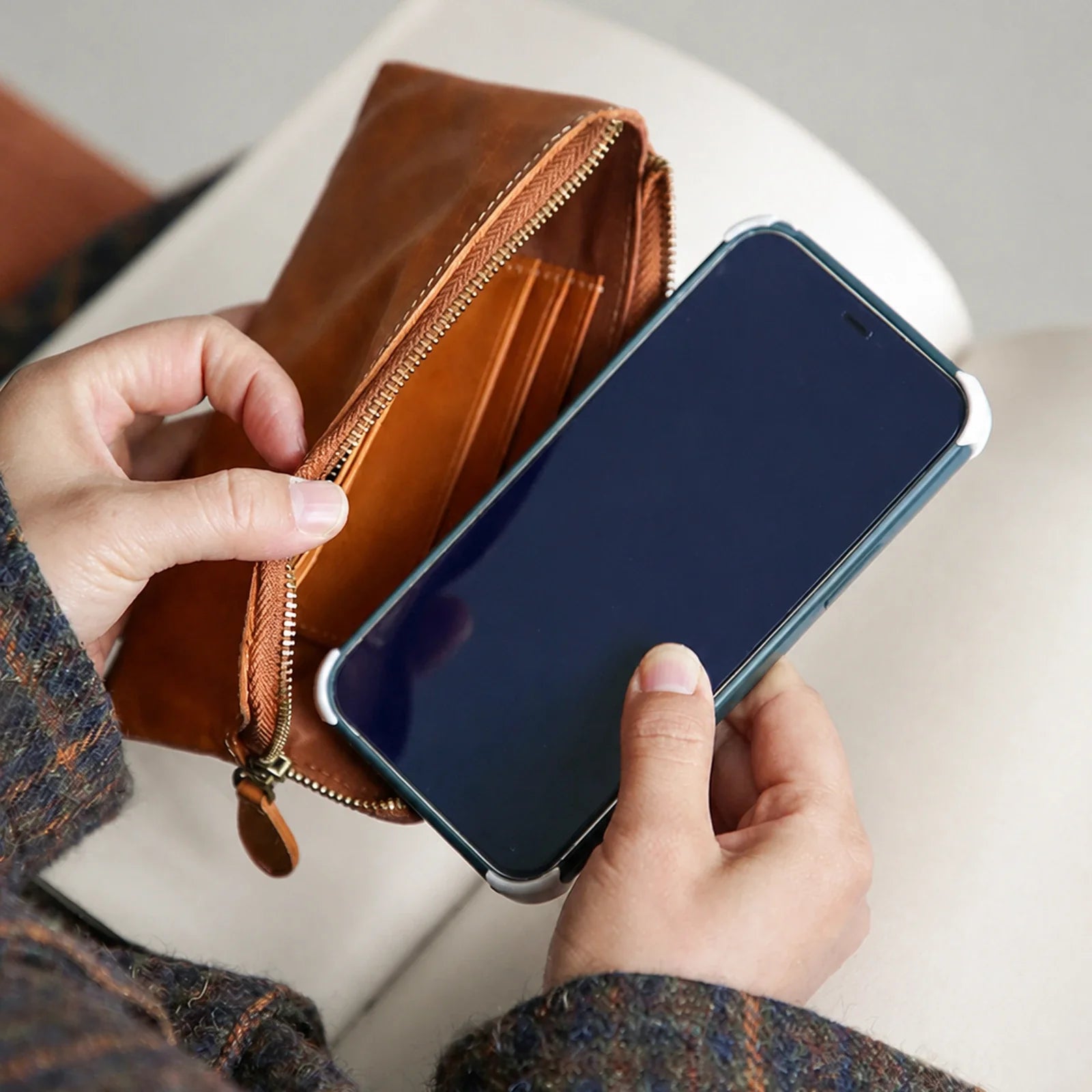 Cognac Brown leather wallet shown with a smartphone