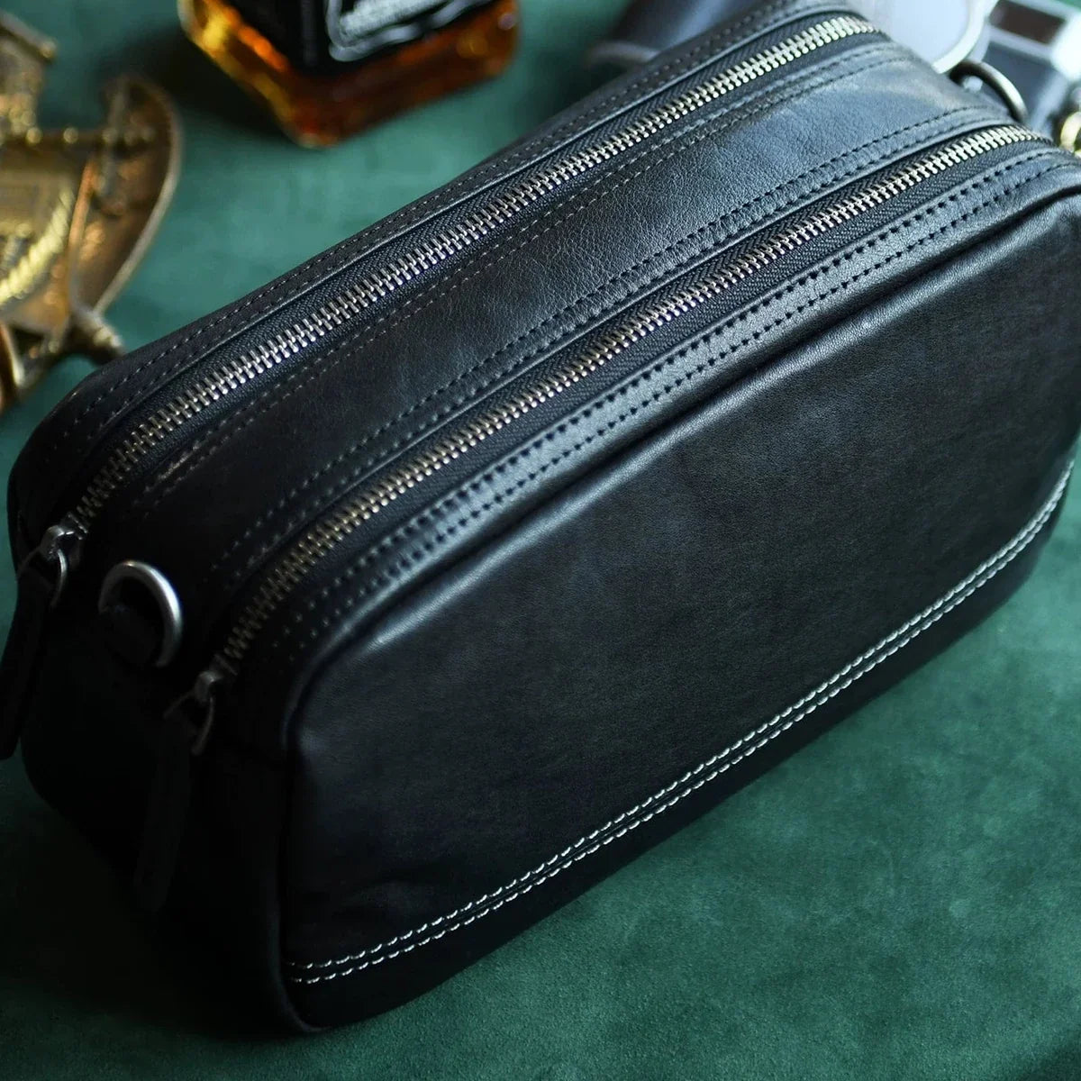 Dual top zipper and cowhide leather grain detail