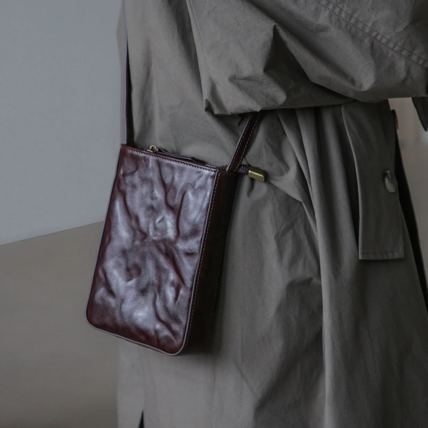 Ebony Coffee leather phone bag, shoulder-worn view