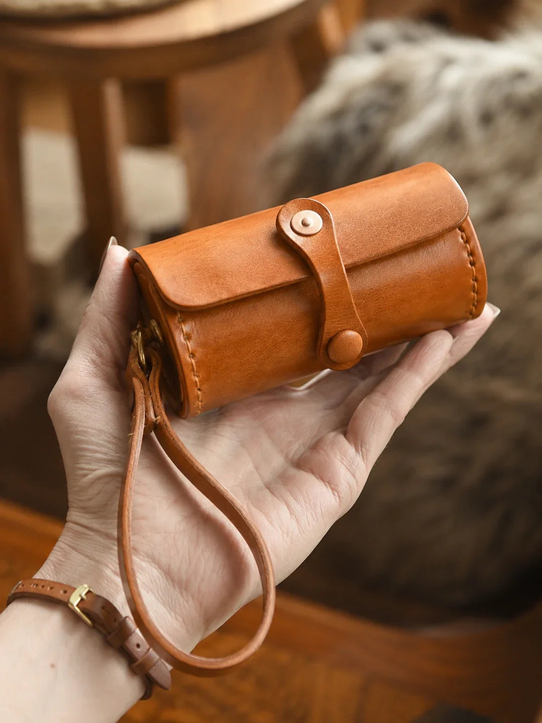 Handheld vegetable-tanned cowhide wristlet case in sunset tan