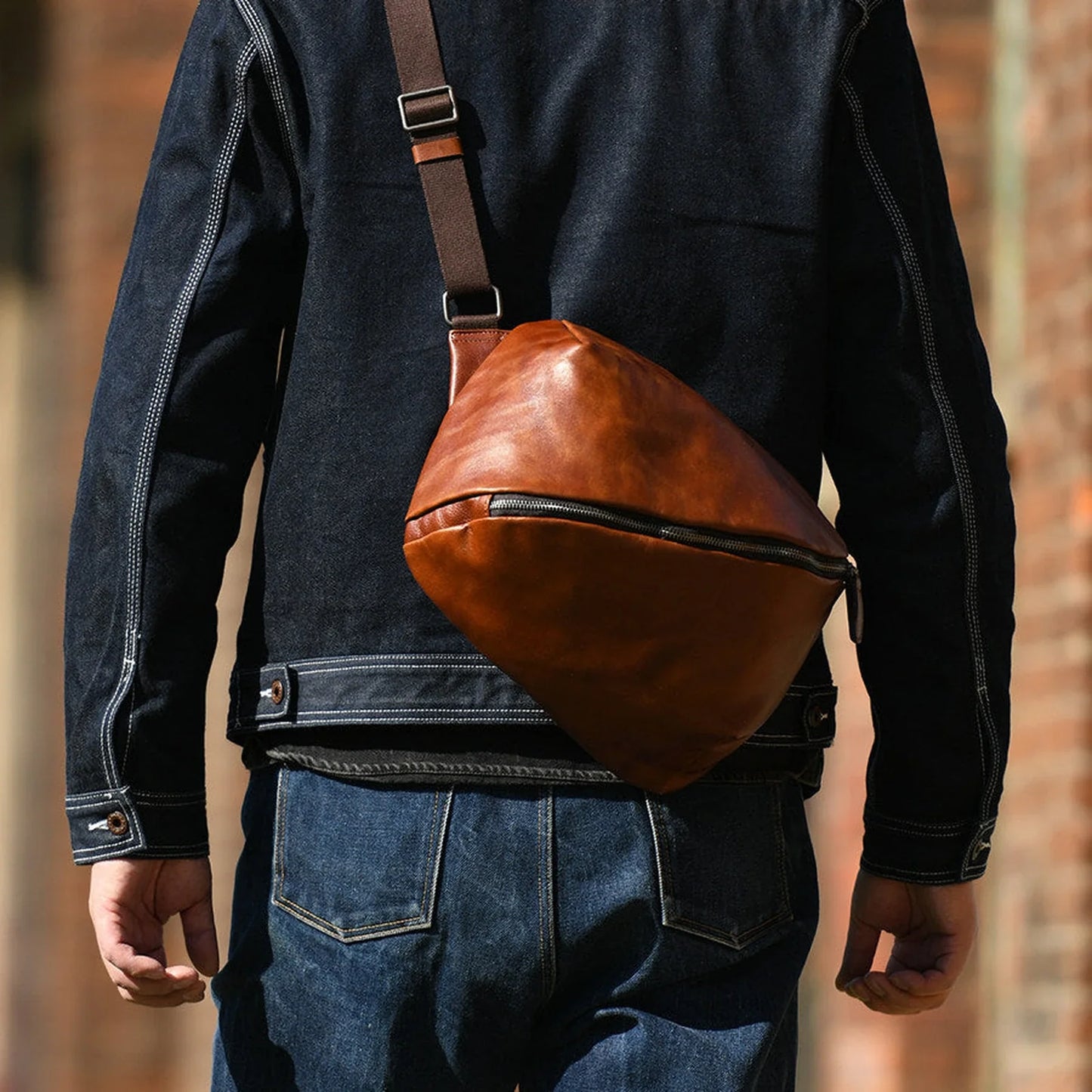 Leather crossbody bag worn across the back