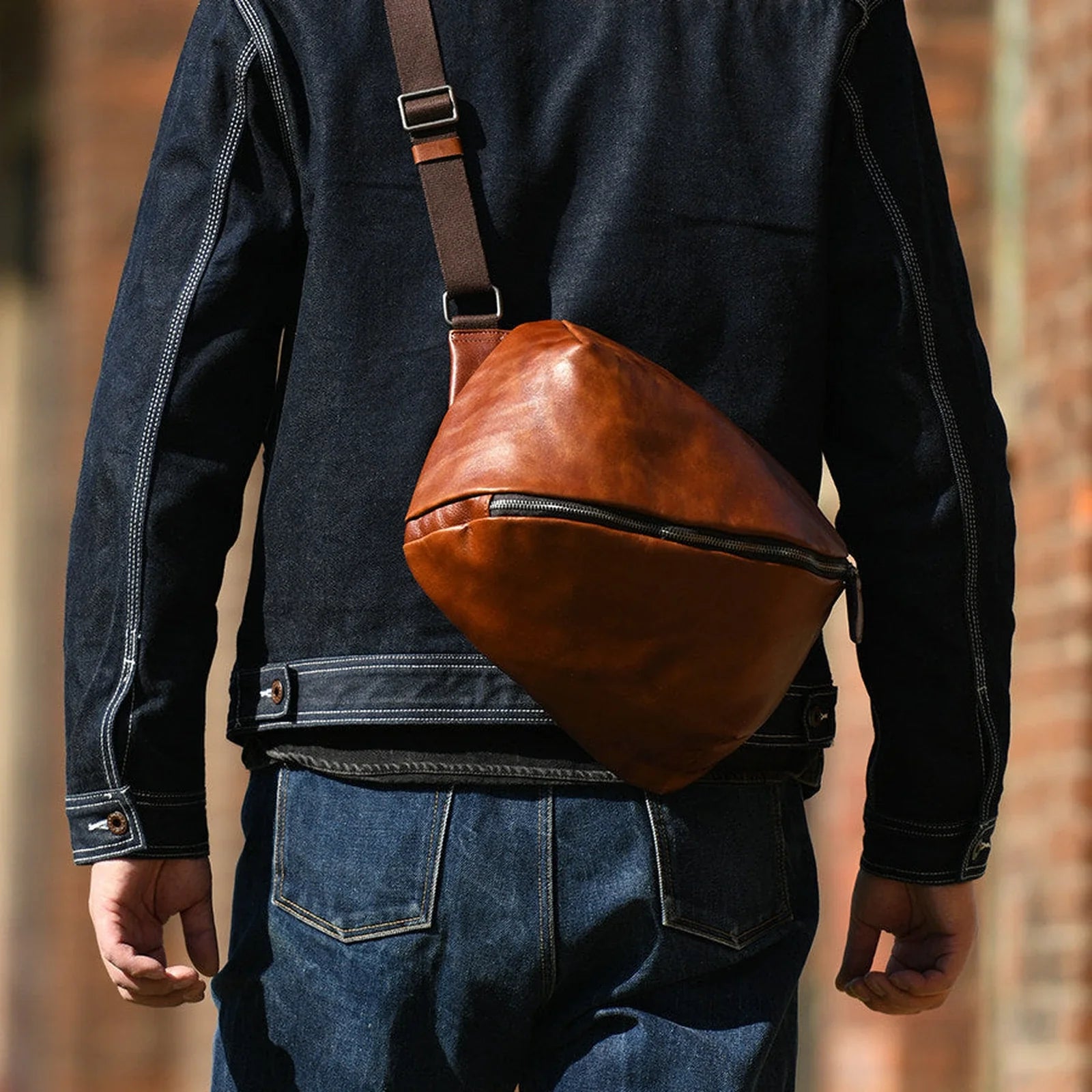 Leather crossbody bag worn across the back