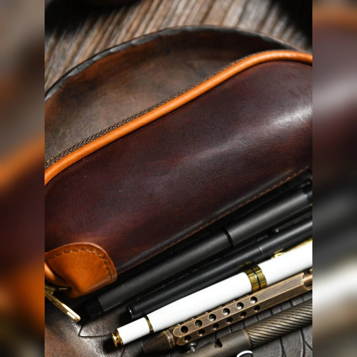 Leather pencil case styled with pens and writing tools