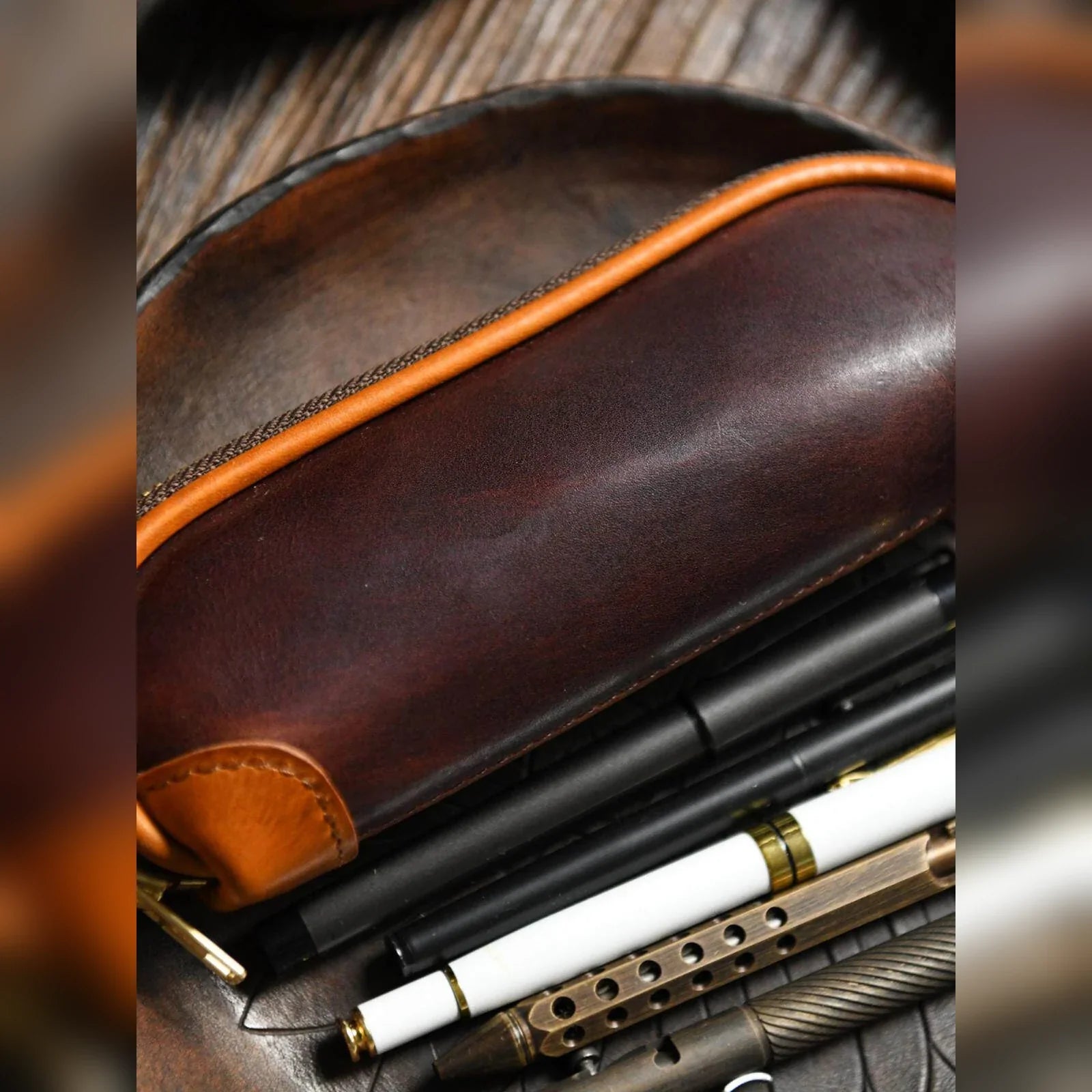 Leather pencil case styled with pens and writing tools