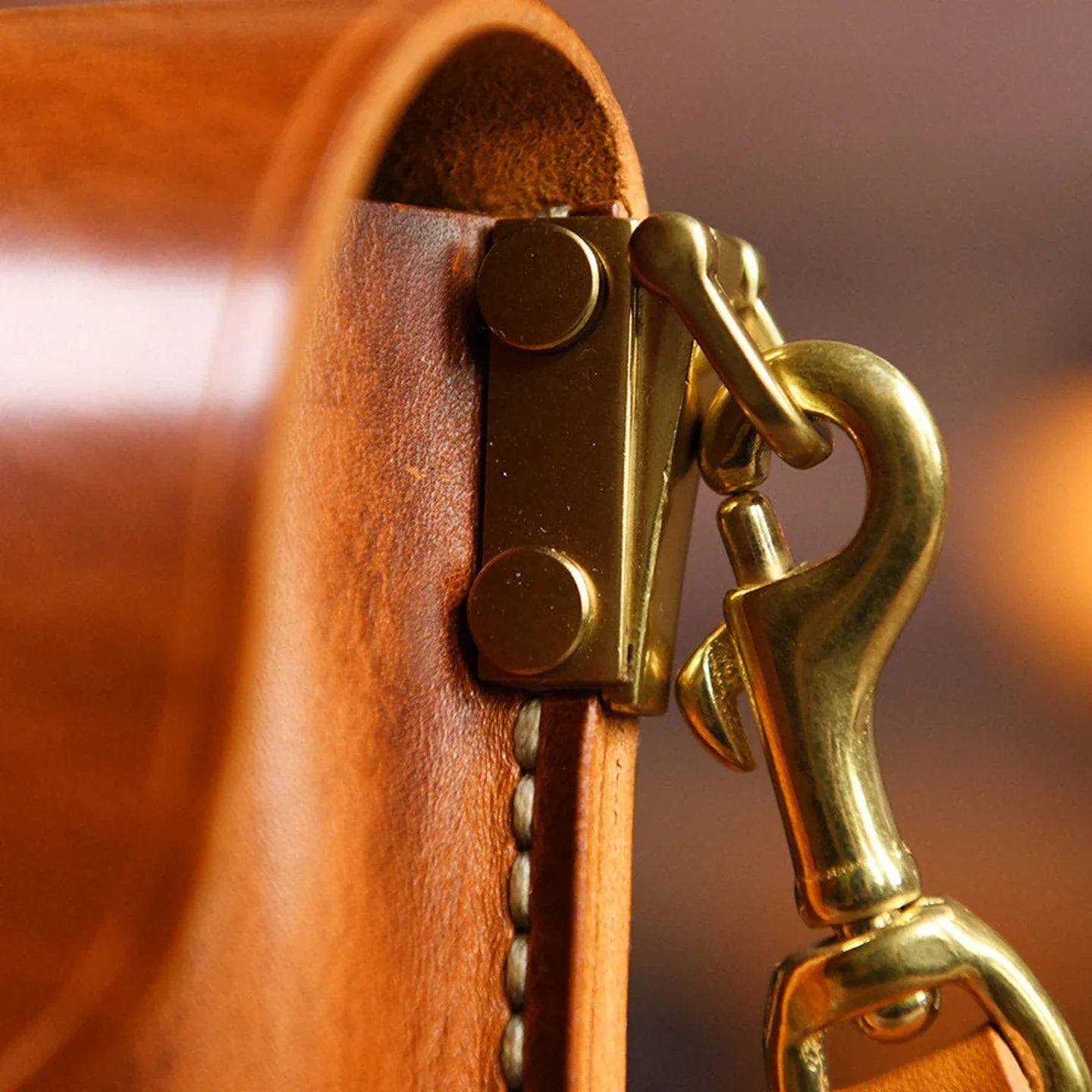 Leather strap attachment and brass hook hardware detail