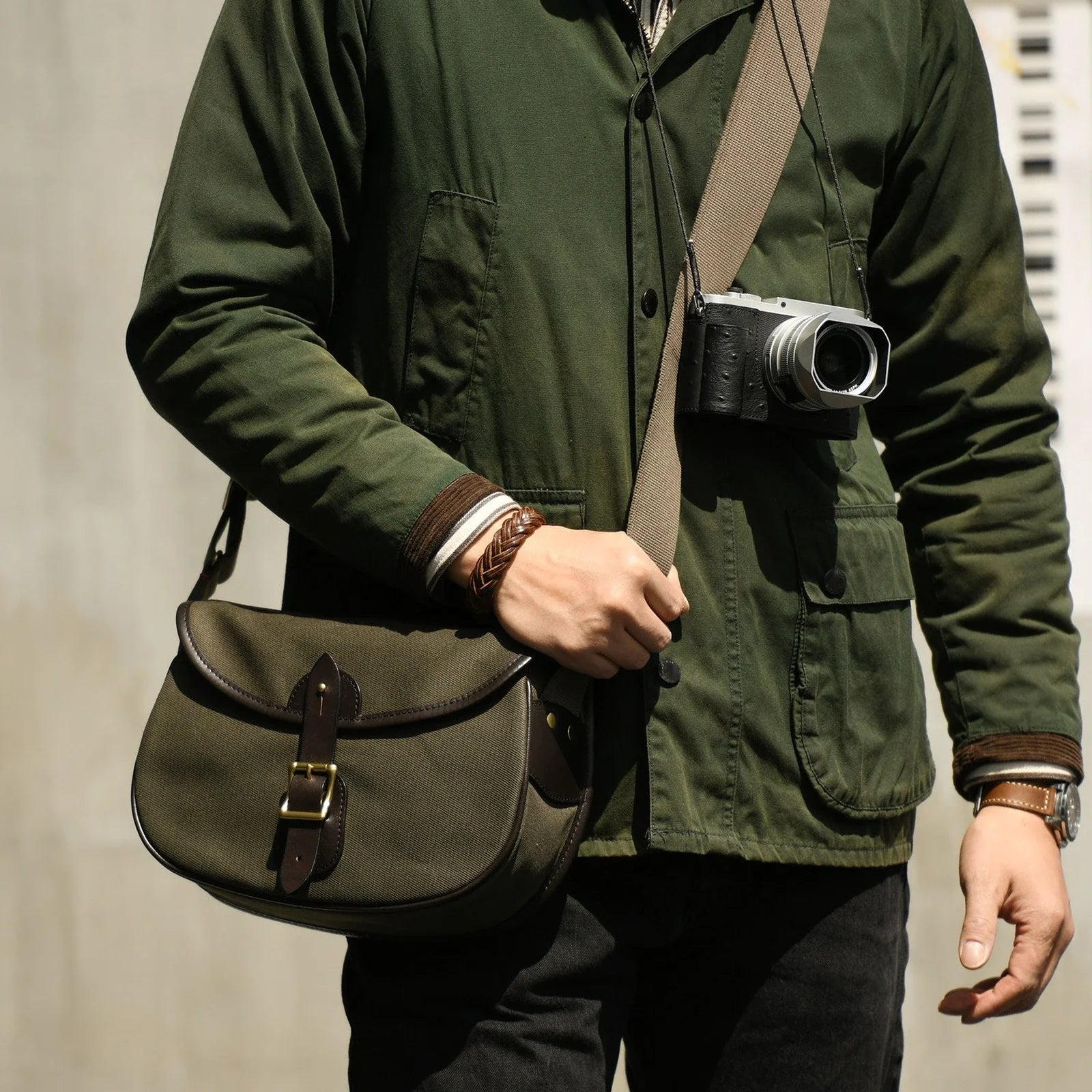Olive green waxed canvas camera bag worn crossbody