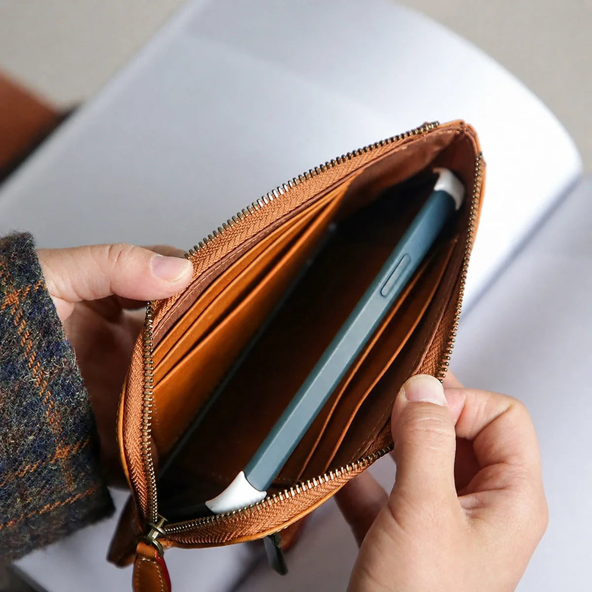 Cowhide wallet interior shown holding a mobile phone