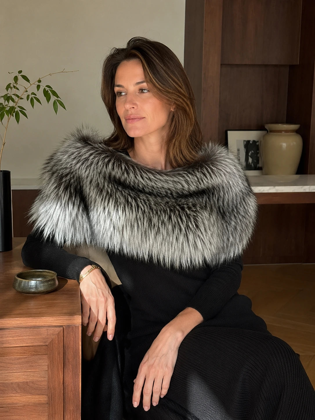 Woman styling the Silver Black fox fur shoulder wrap indoors