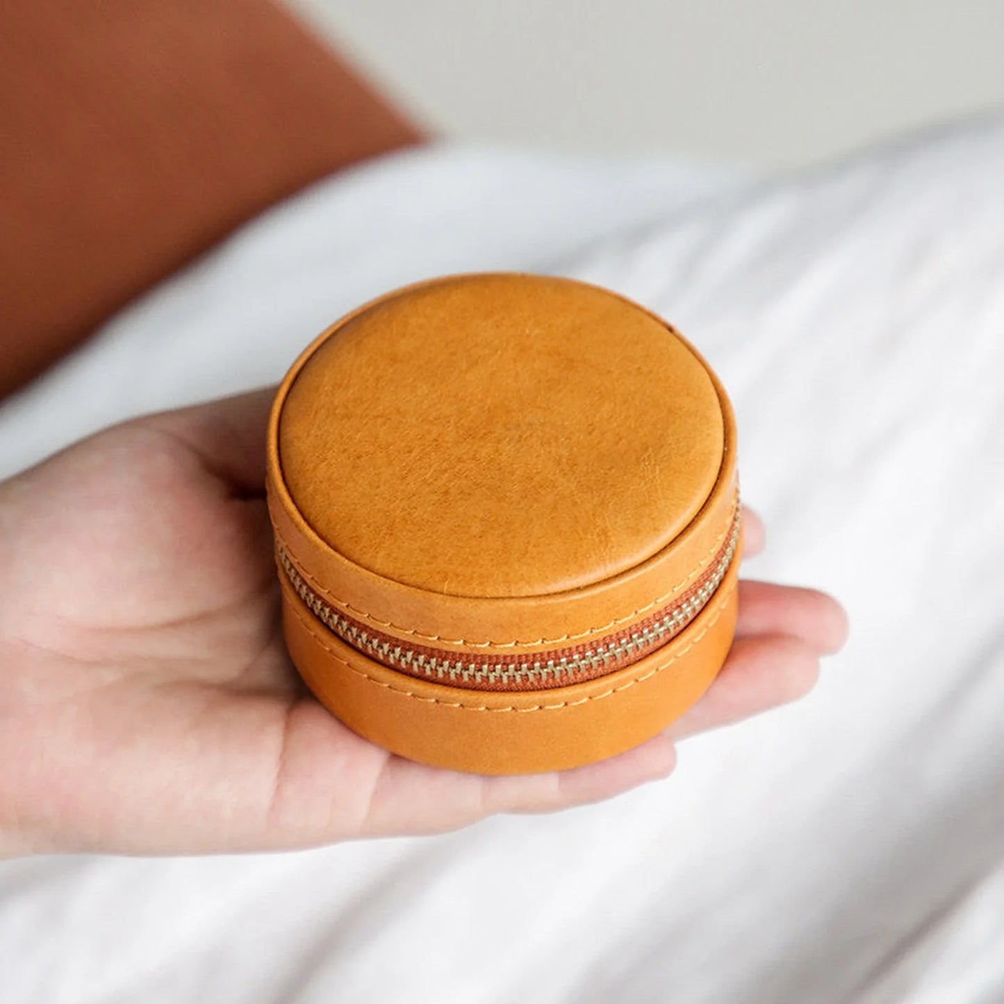 Sunset Ochre round vegetable-tanned leather travel jewelry case with zipper closure