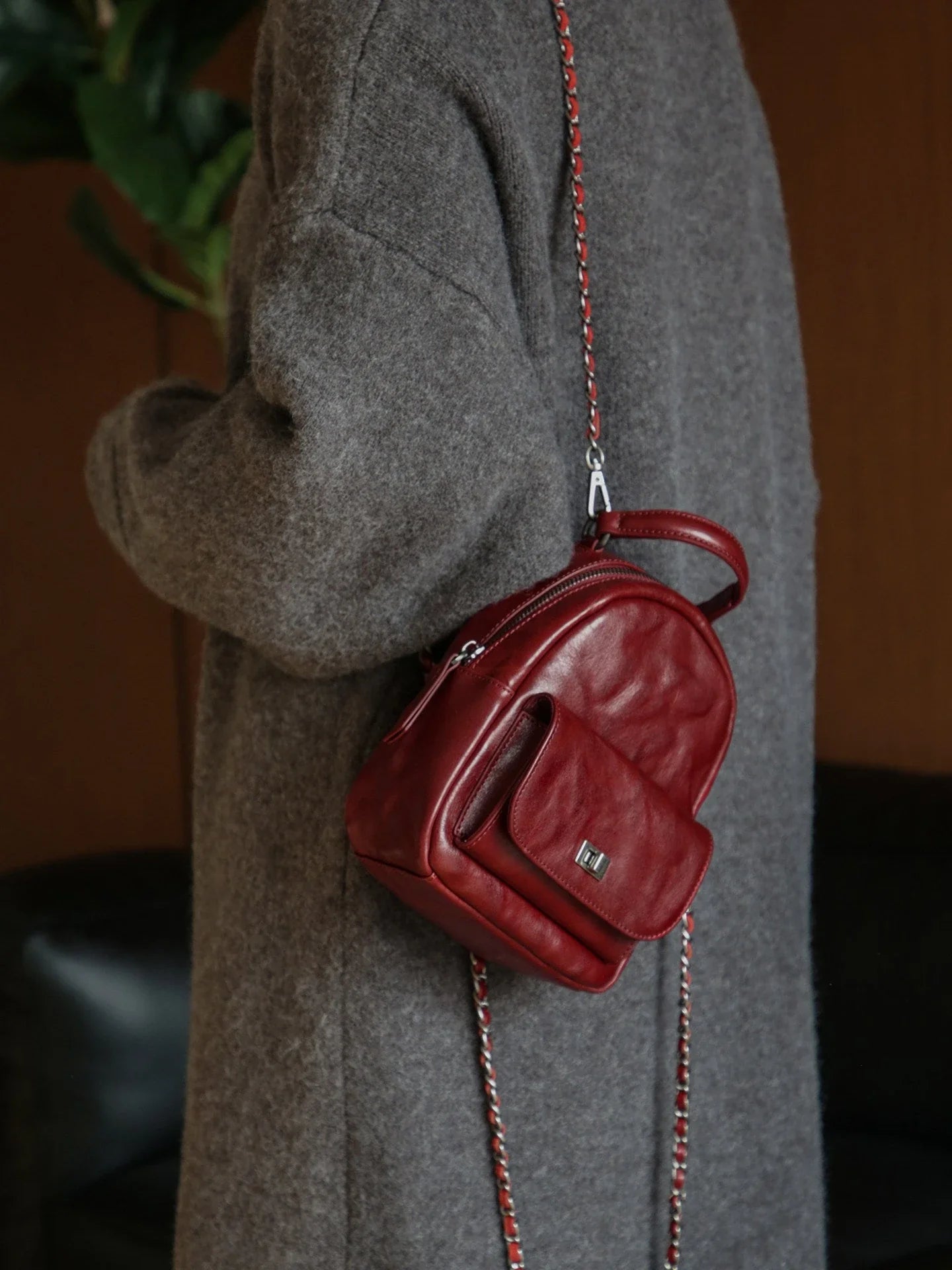 Chestnut brown vegetable-tanned leather mini backpack shown from the side