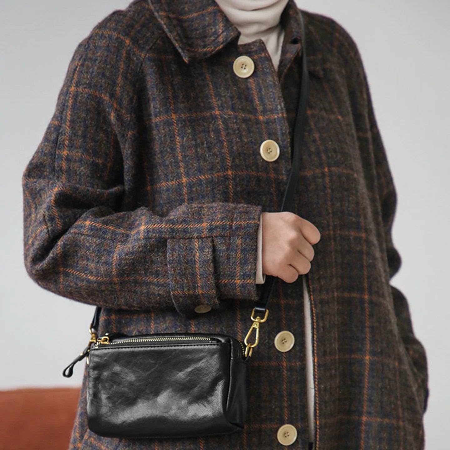 Front view of the black top-grain leather crossbody bag