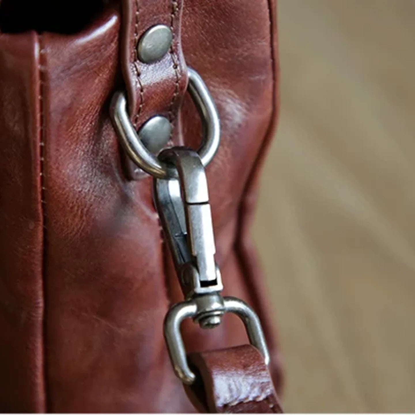 Close-up of the detachable leather shoulder strap hardware