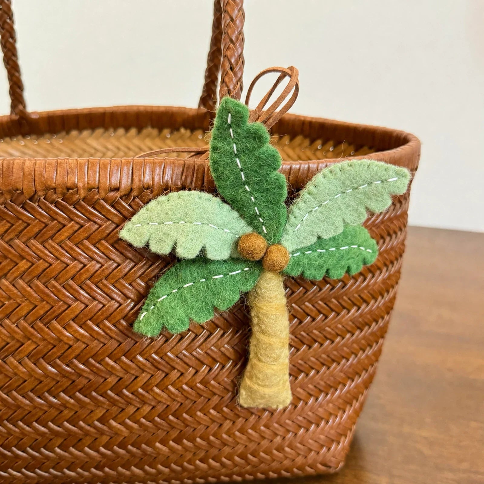 Handmade wool felt palm tree charm with stitched leaves and trunk