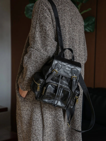 Black vegetable-tanned leather backpack worn on the shoulder