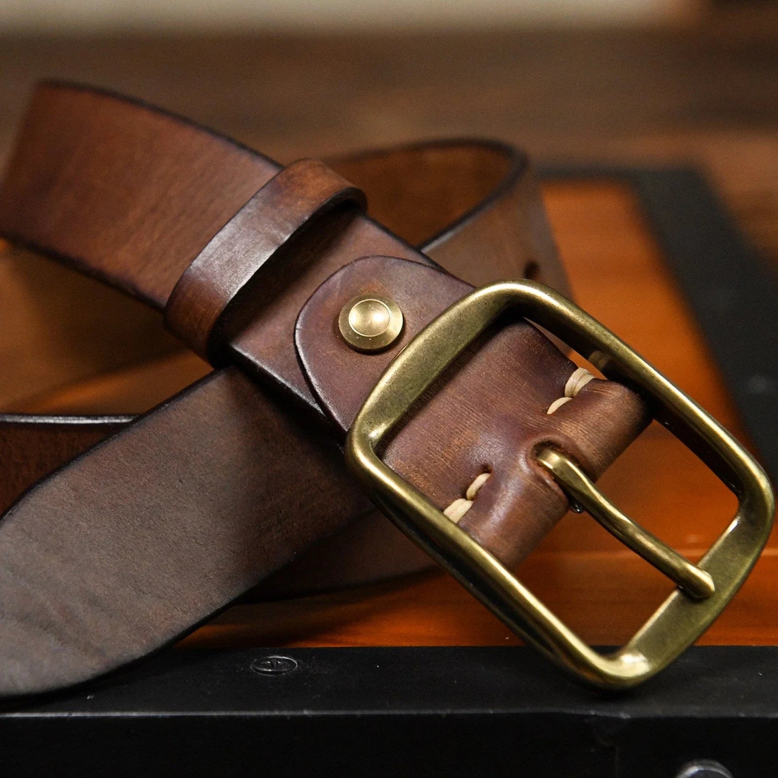 Brown cowhide belt buckle and hand-finished leather detail