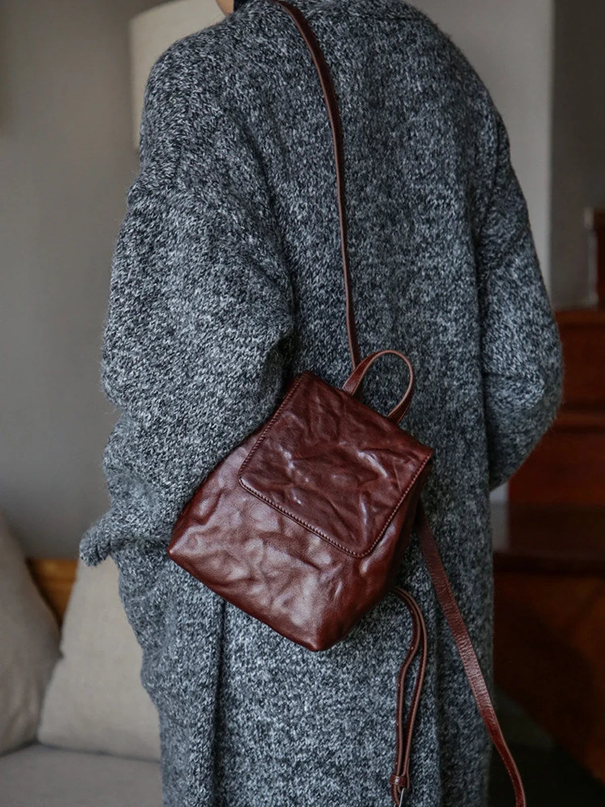 Coffee-brown mini leather backpack worn on the back