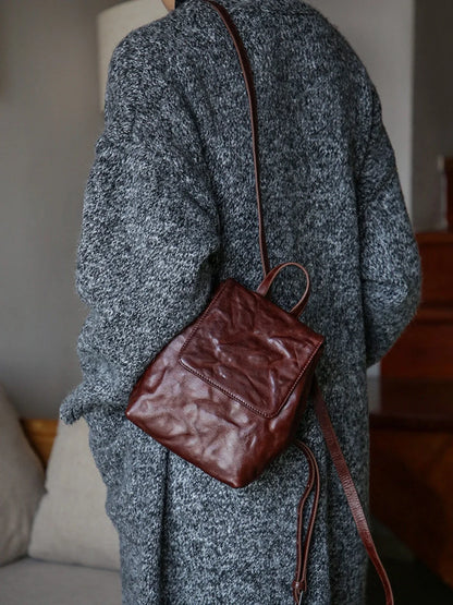 Coffee-brown mini leather backpack worn on the back