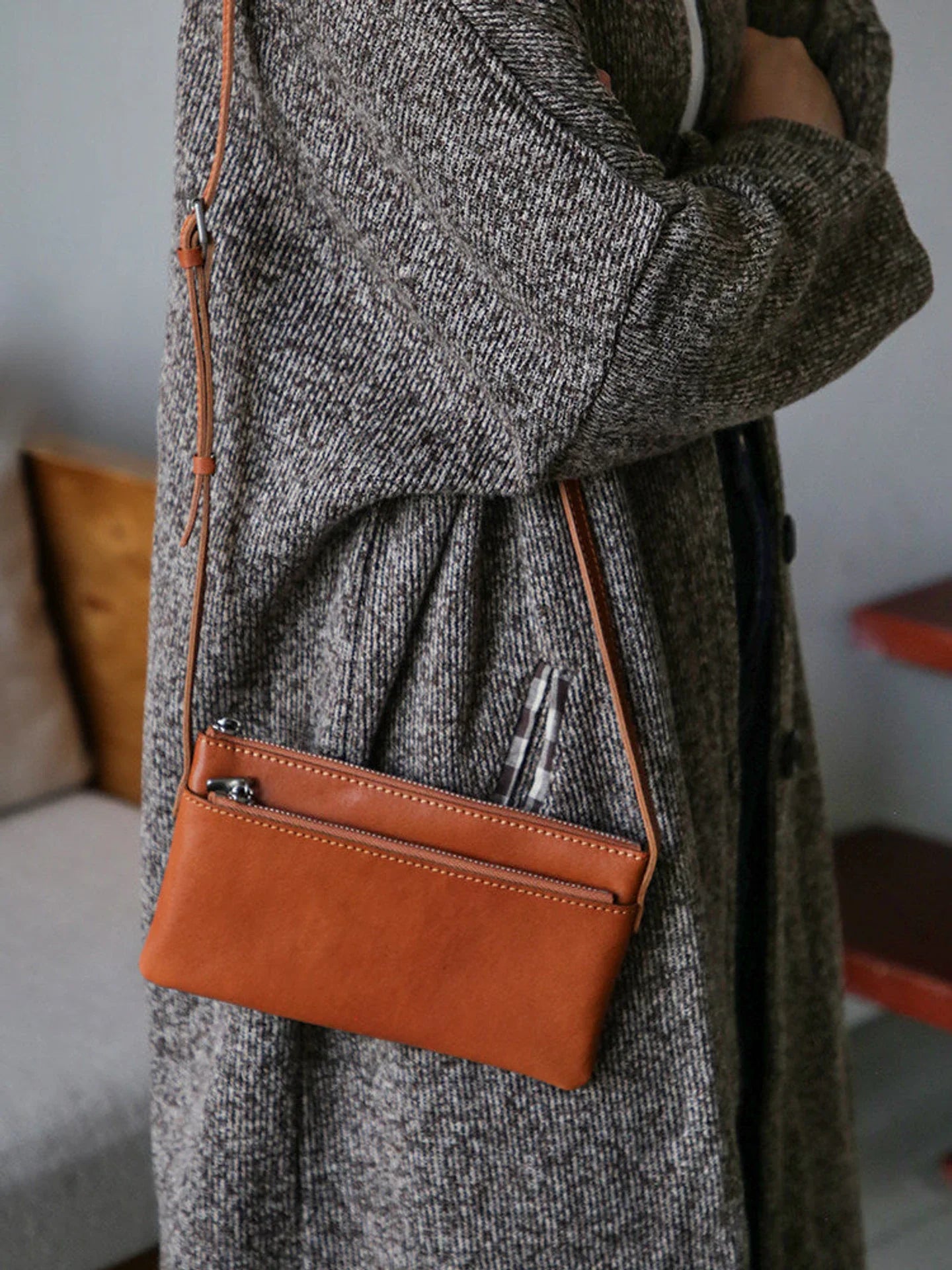 Cognac brown leather phone bag with exterior zipper pocket