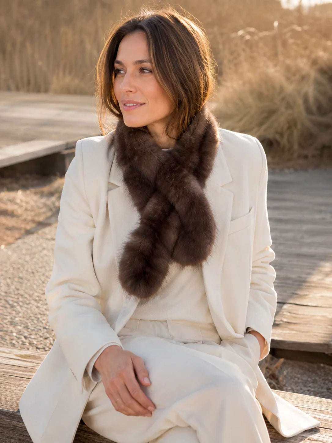 Dark Brown sable fur mini scarf styled with an ivory suit outdoors