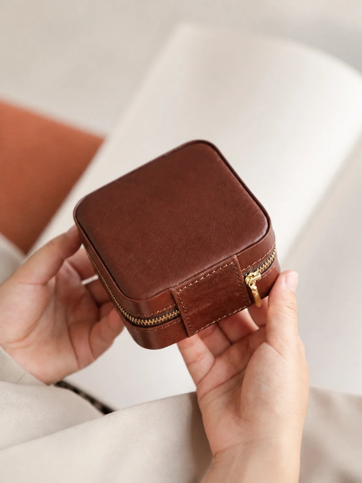 Deep brown vegetable-tanned leather travel jewelry case with zip closure