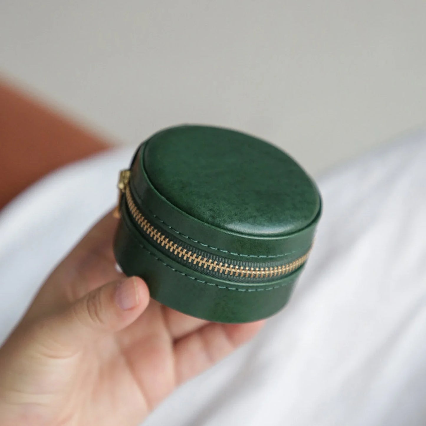 Forest Green round vegetable-tanned leather travel jewelry case with zipper closure
