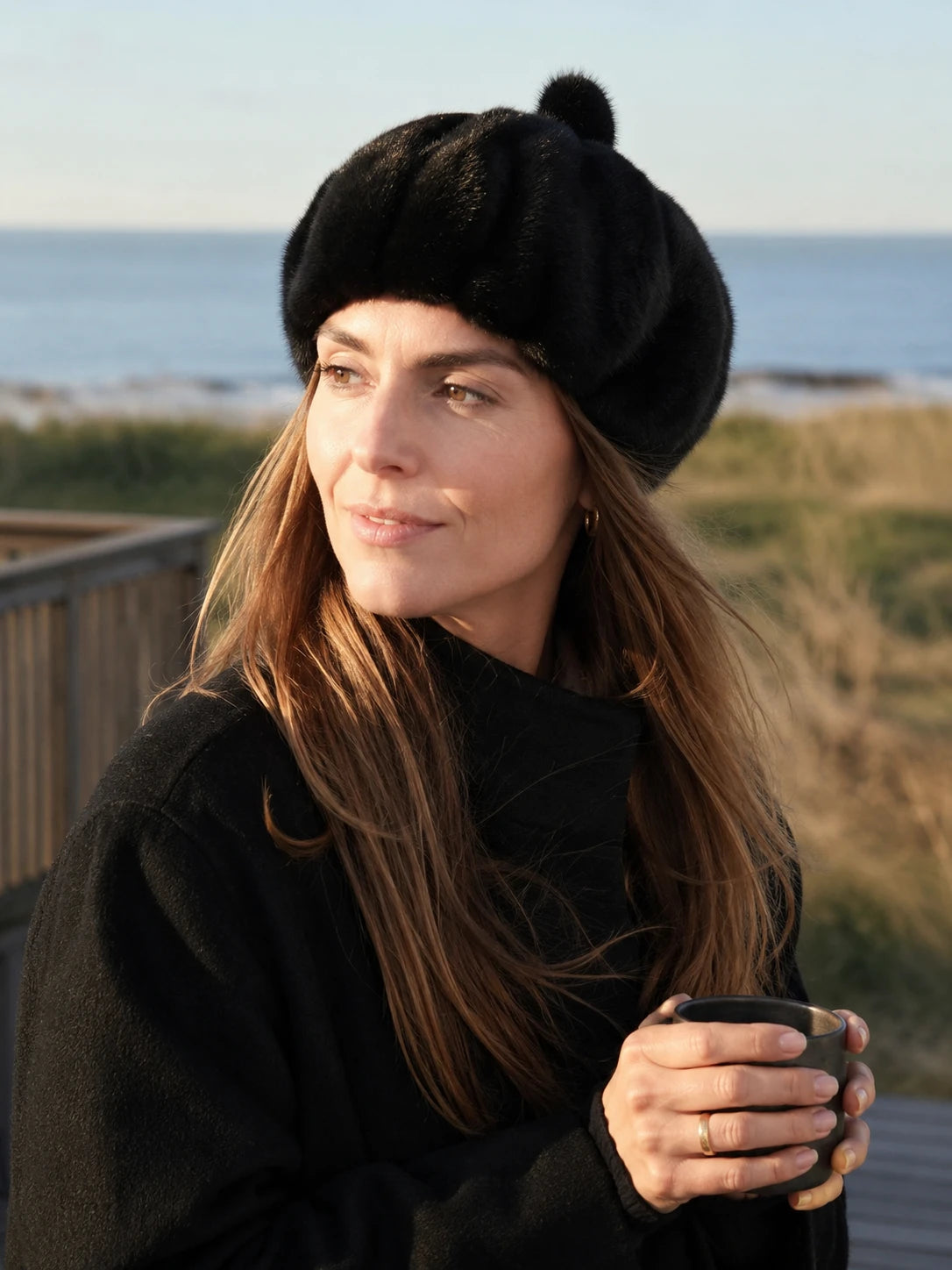 Woman styling a Natural Black genuine mink fur beret by the coast