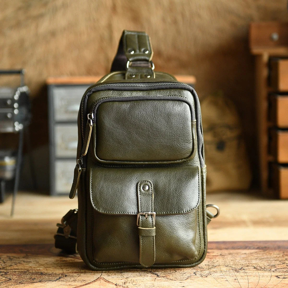 Olive green leather sling bag studio front view