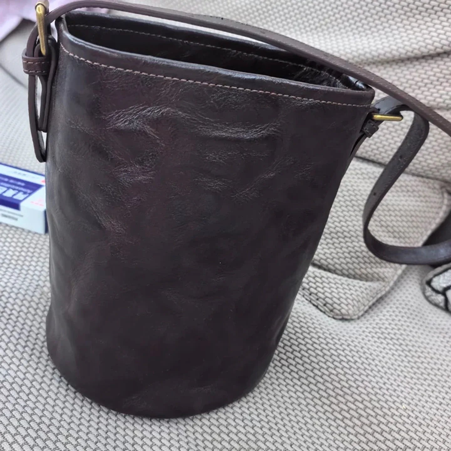 Rear view of the ebony brown top-grain leather bucket bag