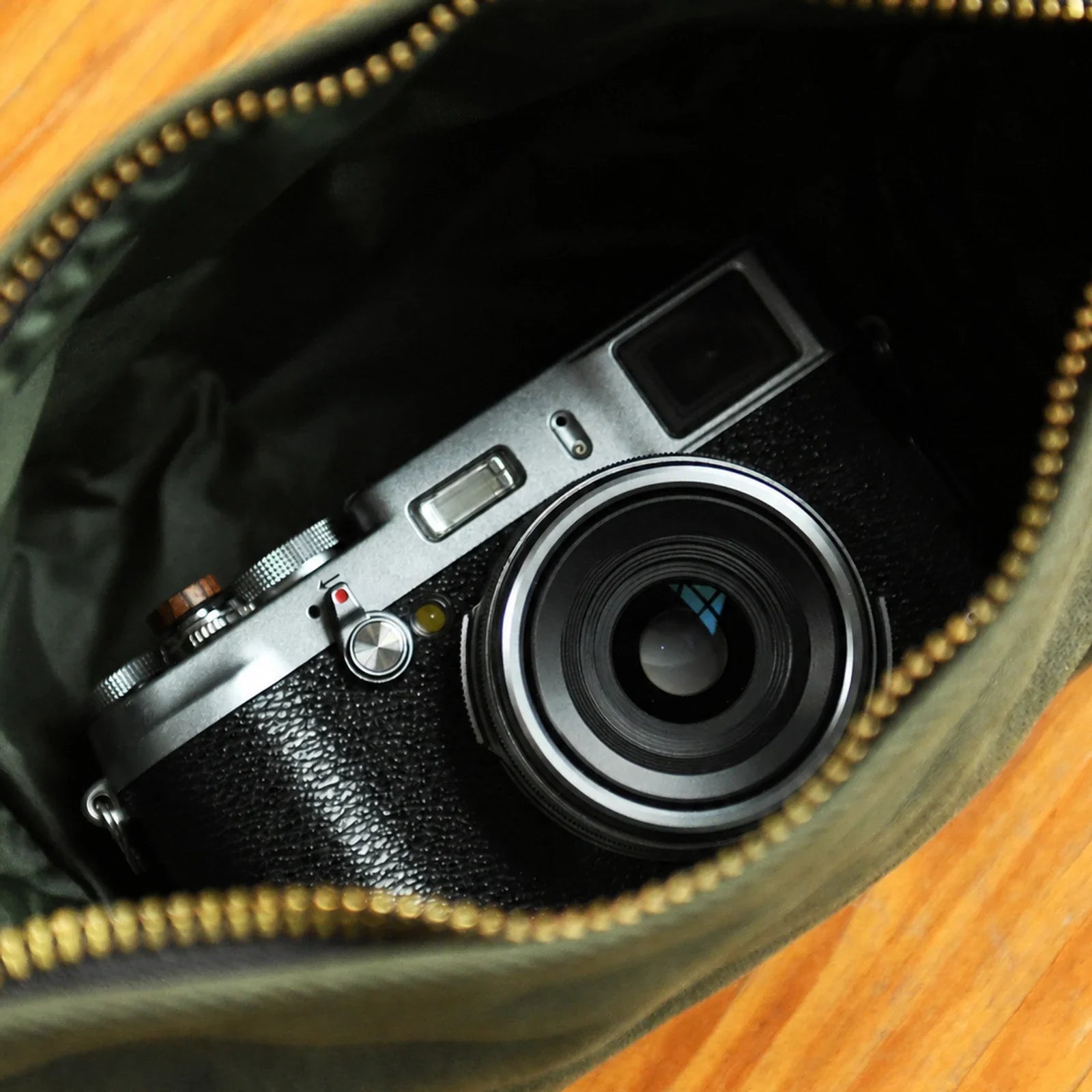 Waxed canvas pouch open to show the canvas-lined interior
